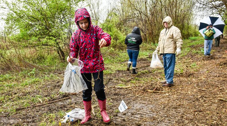 Addison Lanich, 12, was one of the volunteers planting one hundred trees at Riverside Natural Area Tuesday, April 24 in Hamilton. NICK GRAHAM/STAFF