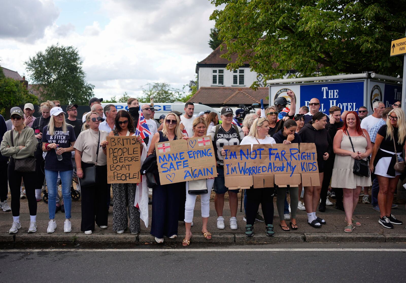 Protesters demonstrate outside the Bell Hotel in the town of Epping, Essex, England, Sunday, July 20, 2025. (Yui Mok/PA via AP)