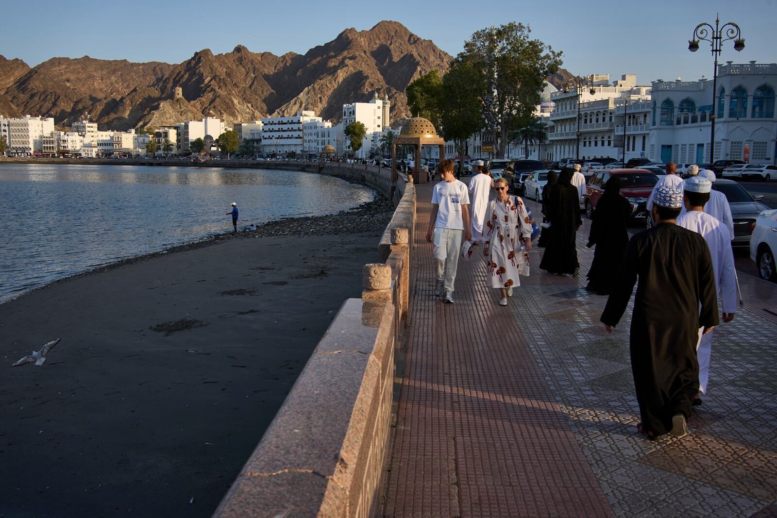 Visitors and locals gather at the Mutrah Corniche in Muscat, Oman, Friday, April 11, 2025. (AP Photo/ Fatima Shbair)