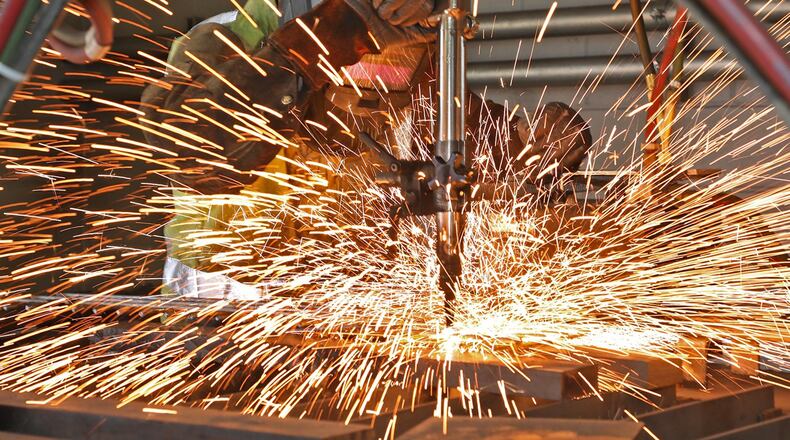A welding student at the Springfield-Clark CTC cuts a piece of metal in this 2018 file photo. BILL LACKEY/STAFF