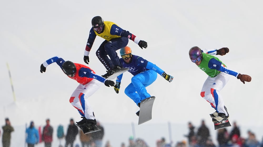 United States' Nick Baumgartner (22), France's Jonas Chollet (4), France's Loan Bozzolo (5), Italy's Lorenzo Sommariva (6) compete during the men's snowboard cross finals at the 2026 Winter Olympics, in Livigno, Italy, Thursday, Feb. 12, 2026. (AP Photo/Lindsey Wasson)