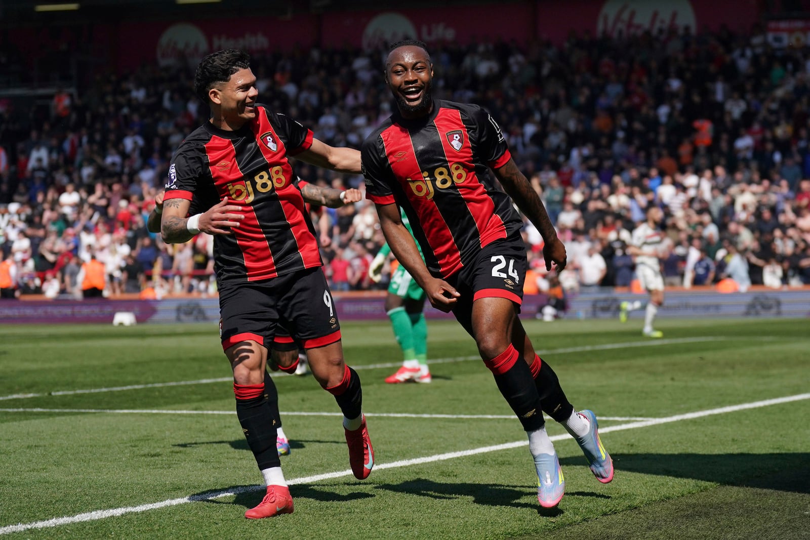 Bournemouth's Antoine Semenyo, right, celebrates after scoring the opening goal during the English Premier League match at Vitality Stadium, Bournemouth, England, Sunday, April 27, 2025. (Adam Davy/PA via AP)