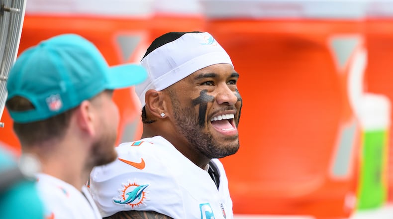 FILE - Miami Dolphins quarterback Tua Tagovailoa smiles on the bench during an NFL football game against the New Orleans Saints, Nov. 30, 2025, in Miami Gardens, Fla. (AP Photo/Doug Murray, File)