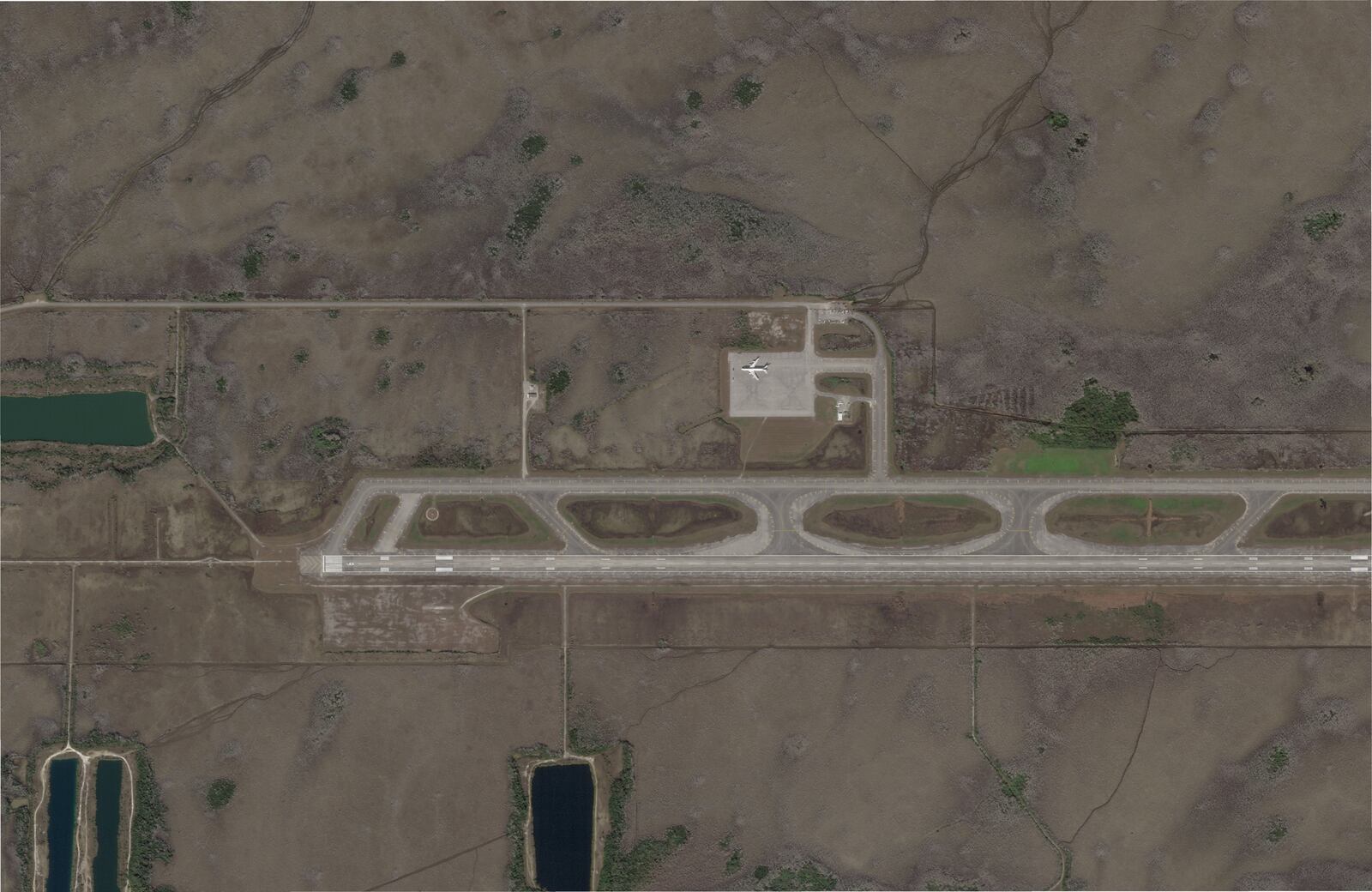 This satellite photo captured by Planet Labs PBC on Feb. 14, 2024, shows an airstrip in Ochopee, Fla., in the Everglades, more than a year before state officials began constructing a state immigration detention facility. (Planet Labs PBC via AP)