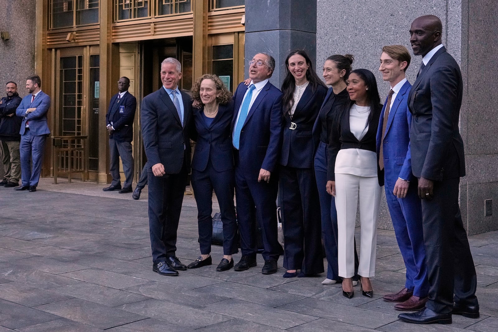 Defense attorneys for Sean "Diddy" Combs, including from left,, Brian Steel, Alexandra Shapiro, Marc Agnifilo and Teny Garagos and Xavier Donaldson, far right, line up for a group photo outside Manhattan federal court after Sean "Diddy" Combs was denied bail after being convicted of prostitution-related offenses but acquitted of sex trafficking and racketeering charges, Wednesday, July 2, 2025, in New York. (AP Photo/Yuki Iwamura)