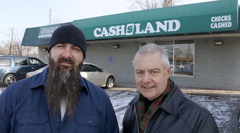 Carl Ruby, pastor of the Central Christian Church, right, and Derek Drewery, pator New Day Christian Fellowship, talk about the high interest rates at payday lenders in the Springifeld area. Bill Lackey/Staff