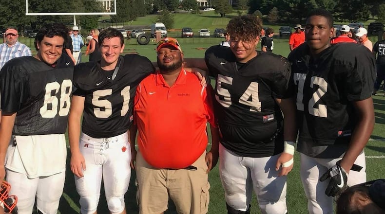 Cornell Strother, center, is pictured with Woodberry Forest players.