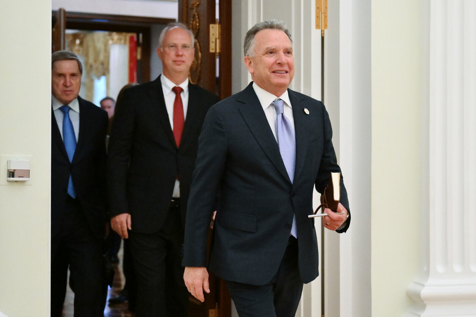 U.S. President Donald Trump's special envoy Steve Witkoff, foreground, President Vladimir Putin's investment envoy Kirill Dmitriev, second left, and Russian Presidential Aide Yuri Ushakov, left, arrive to attend the talks with Russian President Vladimir Putin at the Kremlin in Moscow, Russia, Friday, April 25, 2025. (Kristina Kormilitsyna, Sputnik, Kremlin Pool Photo via AP)