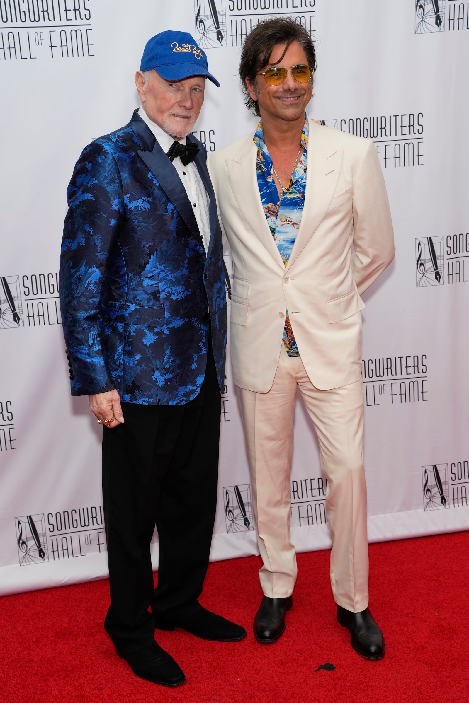 Mike Love, left, and John Stamos attend the 54th annual Songwriters Hall of Fame induction and awards gala on Thursday, June 12, 2025, at the Marriott Marquis Hotel in New York. (Photo by Charles Sykes/Invision/AP)