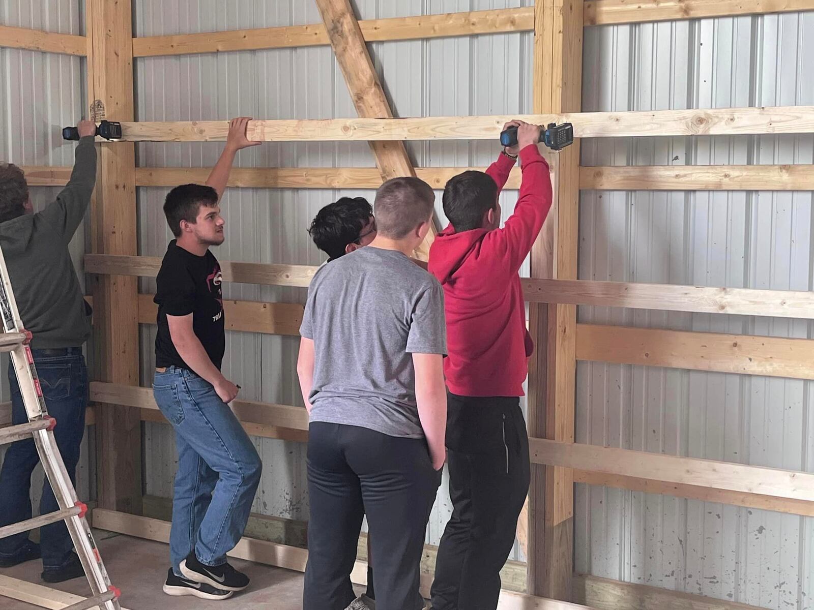 Students doing some of the work on Triad Local School District’s new agricultural FFA barn. Contributed