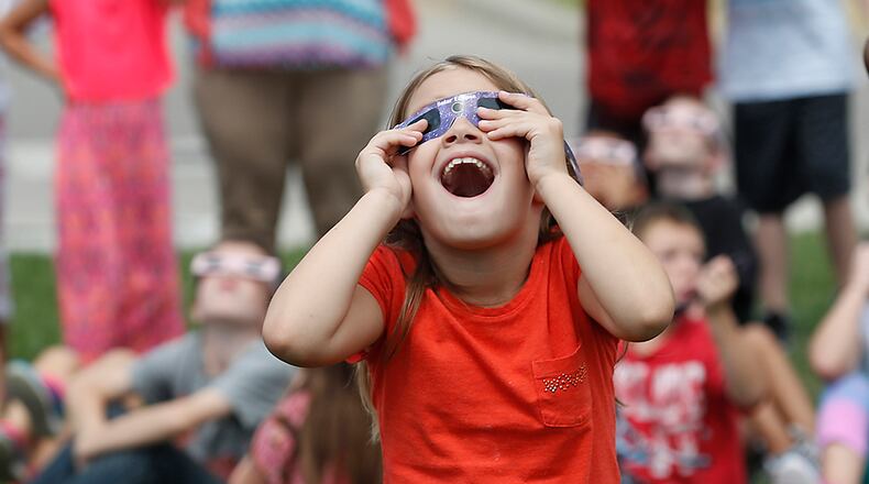 A young student at Horace Mann Elemantary seems amazed as the clouds break up revealing the solar eclipse on Aug. 21, 2017. The photo was among three by Staff Photographer Bill Lackey nominated for best feature photo. Bill Lackey/Staff