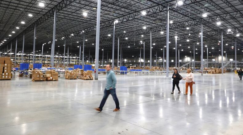 Members of the public arrive as Gabe’s welcomed visitors inside for an official ribbon-cutting ceremony for its new 875,000 square foot distribution center Tuesday, April 4, 2023. The Springfield location employs about 250 workers currently, with a goal of 800 to 1,000 within five years. BILL LACKEY/STAFF