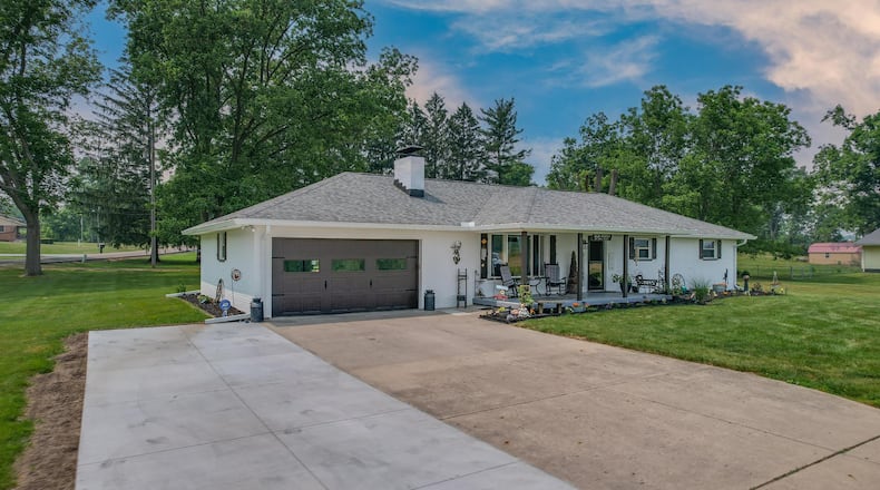The front of the home has a two-car attached garage with opener and high traffic flooring, an extended driveway with additional parking and a covered front porch. CONTRIBUTED PHOTOS