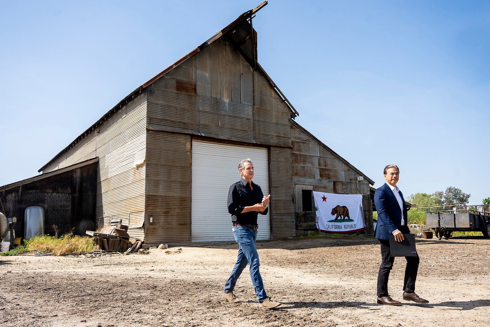 California Gov. Gavin Newsom, left, and California Attorney General Rob Bonta arrive at a press conference about President Donald Trump's tariffs on Wednesday, April 16, 2025, at an almond farm in Ceres, Calif. (AP Photo/Noah Berger)