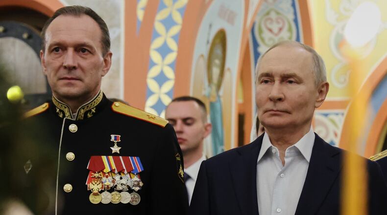 Russian President Vladimir Putin, right, accompanied by military personnel and their families, attends an Orthodox Christmas service at a church in Moscow Region, Russia, on Wednesday, Jan. 7, 2026. (Vyacheslav Prokofyev, Sputnik, Kremlin Pool Photo via AP)