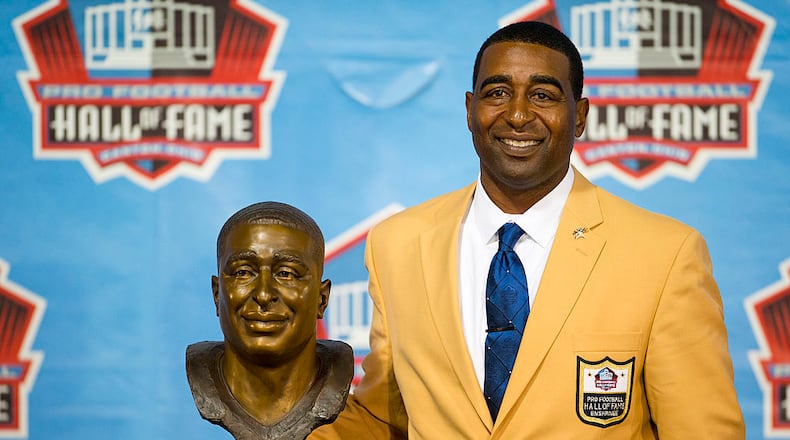 CANTON, OH - AUGUST 3: Former receiver Cris Carter of the Minnesota Vikings poses with his bust during the NFL Class of 2013 Enshrinement Ceremony at Fawcett Stadium on Aug. 3, 2013 in Canton, Ohio. (Photo by Jason Miller/Getty Images)