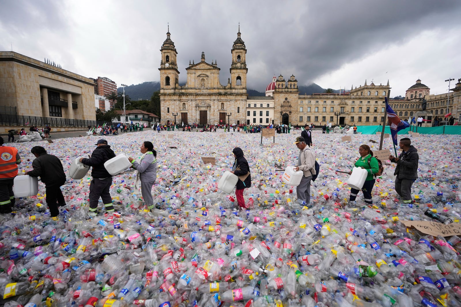 Recyclers wade through plastic bottles blanketing Plaza Bolivar in Bogota, Colombia, as they protest against what recyclers consider to be too low a price paid to them by companies that buy recycled materials, Tuesday, June 24, 2025. (AP Photo/Fernando Vergara)