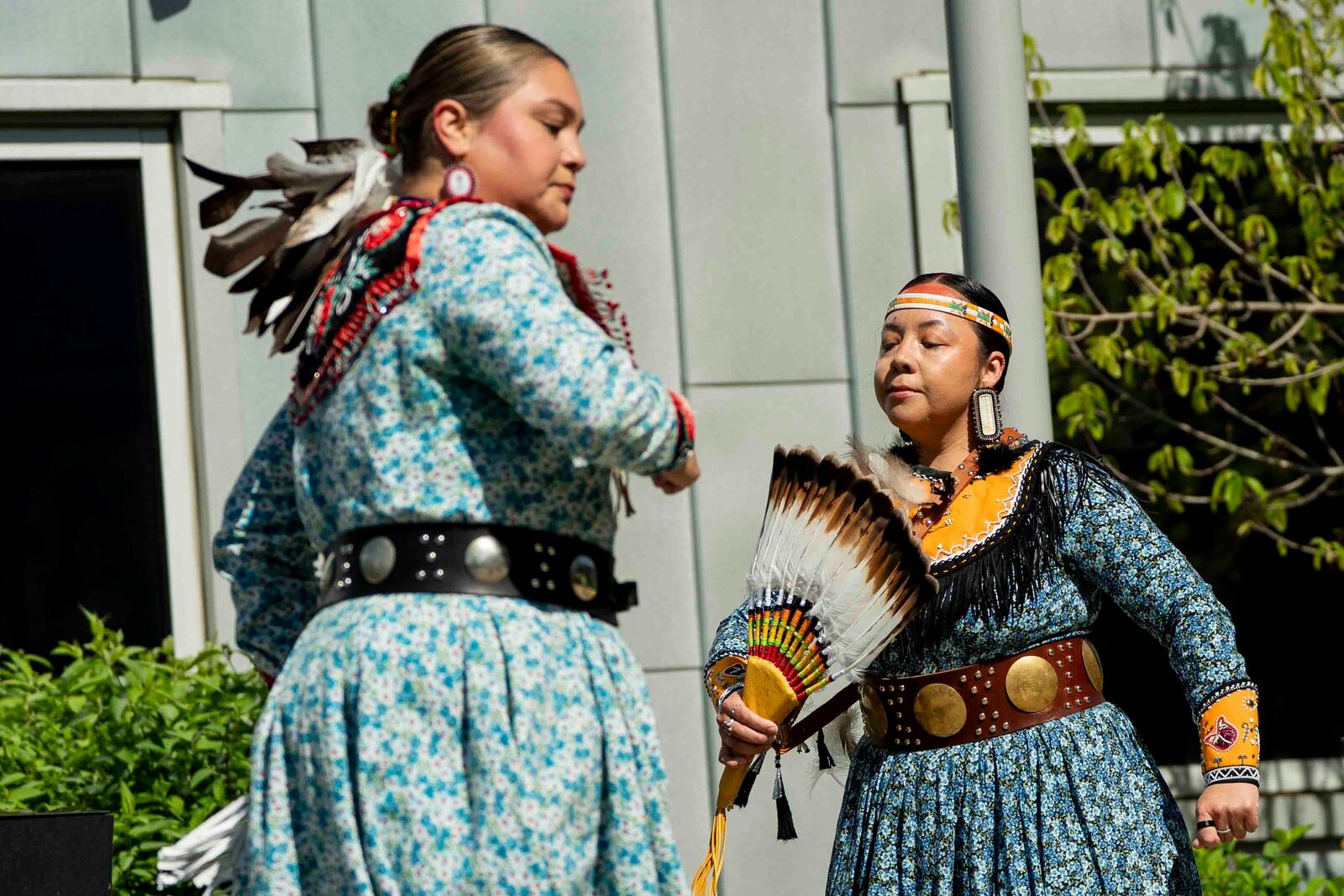 Nicole Hill, left, and Aryien Stevens of the Gëjohgwa' dancers perform before New York Gov. Kathy Hochul's formal apology to the Seneca Nation for New York State's role in operating the Thomas Indian School, Tuesday, May 20, 2025, outside the William Seneca Administration Building in Irving, N.Y. (Libby March/The Buffalo News via AP)