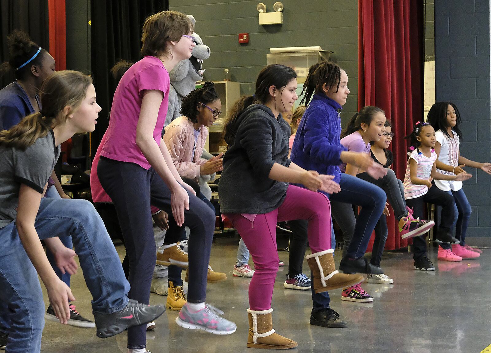 Children in the Lincoln Elementary Promise Neighborhood program try to keep up with a group of Wilberforce University fraternity and sorority members demonstrating “Step Dancing” Wednesday. Bill Lackey/Staff