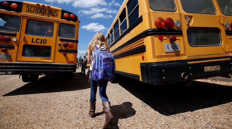 FILE - A student prepares to leave school, Aug. 13, 2014, southeast of Brookhaven, Miss. (AP Photo/Rogelio V. Solis, File)