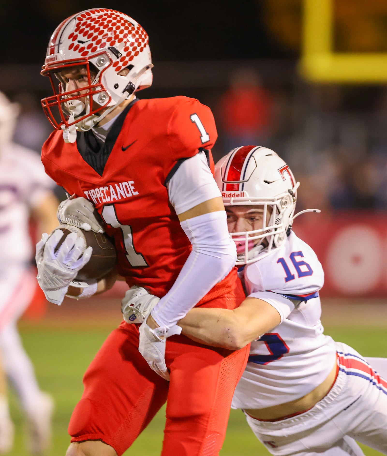 Tippecanoe senior receiver Will Strong runs with pressure from Talawanda's Kemper McAfee during a Division III, Region 12 quarterfinal on Friday, Nov. 7 at Tipp City Park. BRYANT BILLING/STAFF