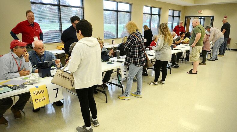 Voters sign in to vote Tuesday, November 7, 2023, at the St. John the Baptist Catholic Church in Tipp City. MARSHALL GORBY \STAFF