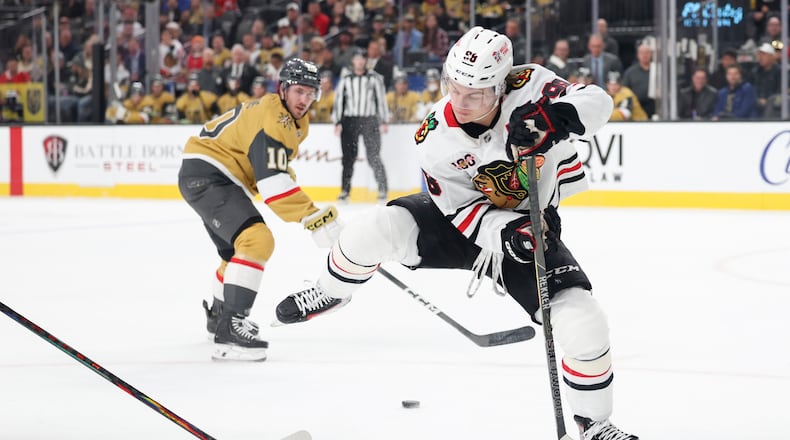 Chicago Blackhawks center Connor Bedard (98) passes the puck against the Vegas Golden Knights during the first period of an NHL hockey game Tuesday, Dec. 2, 2025, in Las Vegas. (AP Photo/Ian Maule)