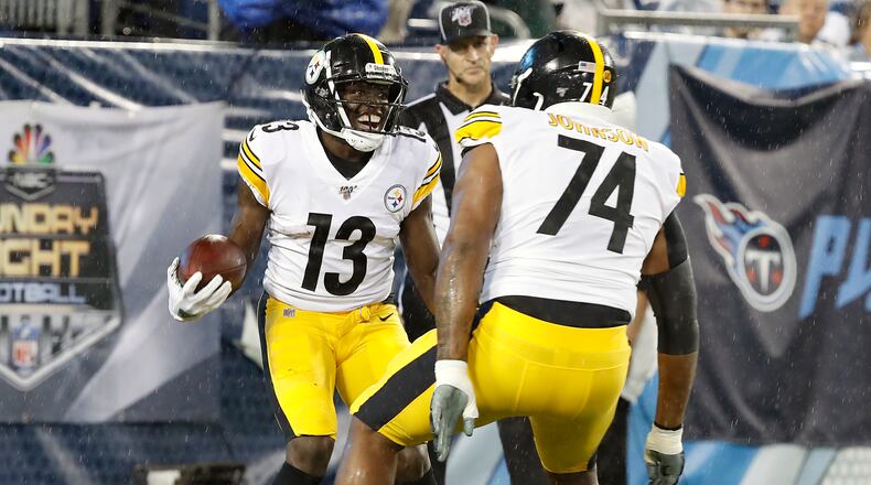 NASHVILLE, TENNESSEE - AUGUST 25: James Washington #13 of the Pittsburgh Steelers is congratulated by teammate Fred Johnson #74 after making a touchdown reception against the Tennessee Titans during the first half of a preseason game at Nissan Stadium on August 25, 2019 in Nashville, Tennessee. (Photo by Frederick Breedon/Getty Images)