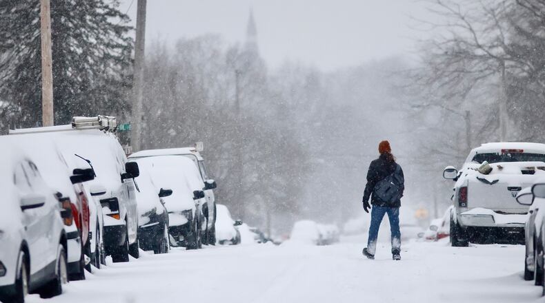 A person braves the snow and cold early Monday morning, Jan. 6, 2025 on Madison Avenue in Springfield. MARSHALL GORBY/STAFF