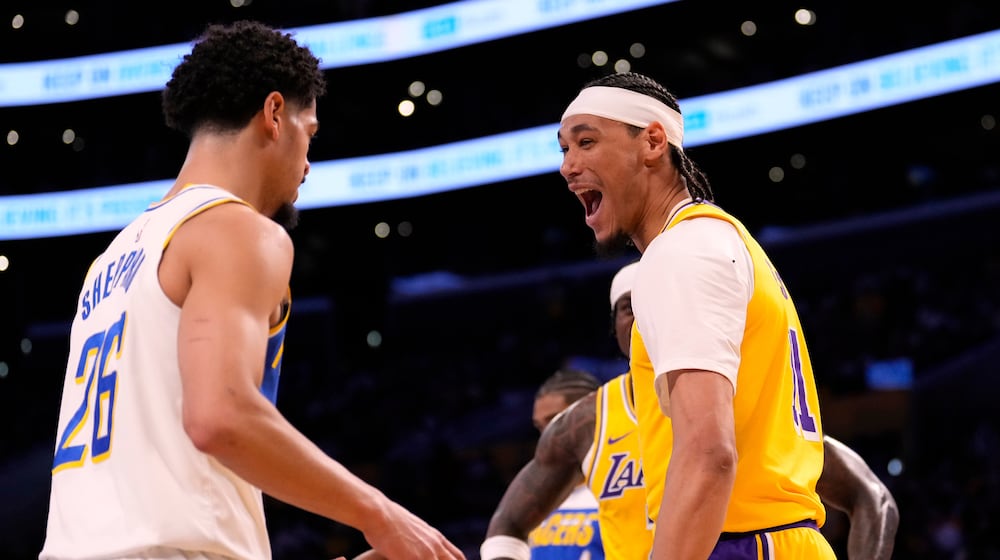 Los Angeles Lakers center Jaxson Hayes, right, jokes with Indiana Pacers guard Ben Sheppard after dunking during the first half of an NBA basketball game Friday, March 6, 2026, in Los Angeles. (AP Photo/Mark J. Terrill)