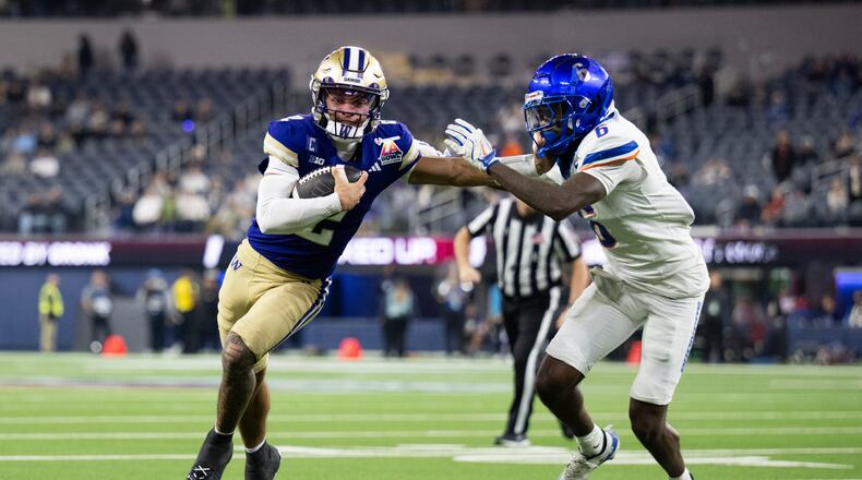 Washington quarterback Demond Williams Jr. (2) applies stiff arm to Boise State defensive back Jeremiah Earby (6) during the second half of the LA Bowl NCAA college football game Saturday, Dec. 13, 2025, in Inglewood, Calif. (AP Photo/Kyusung Gong)