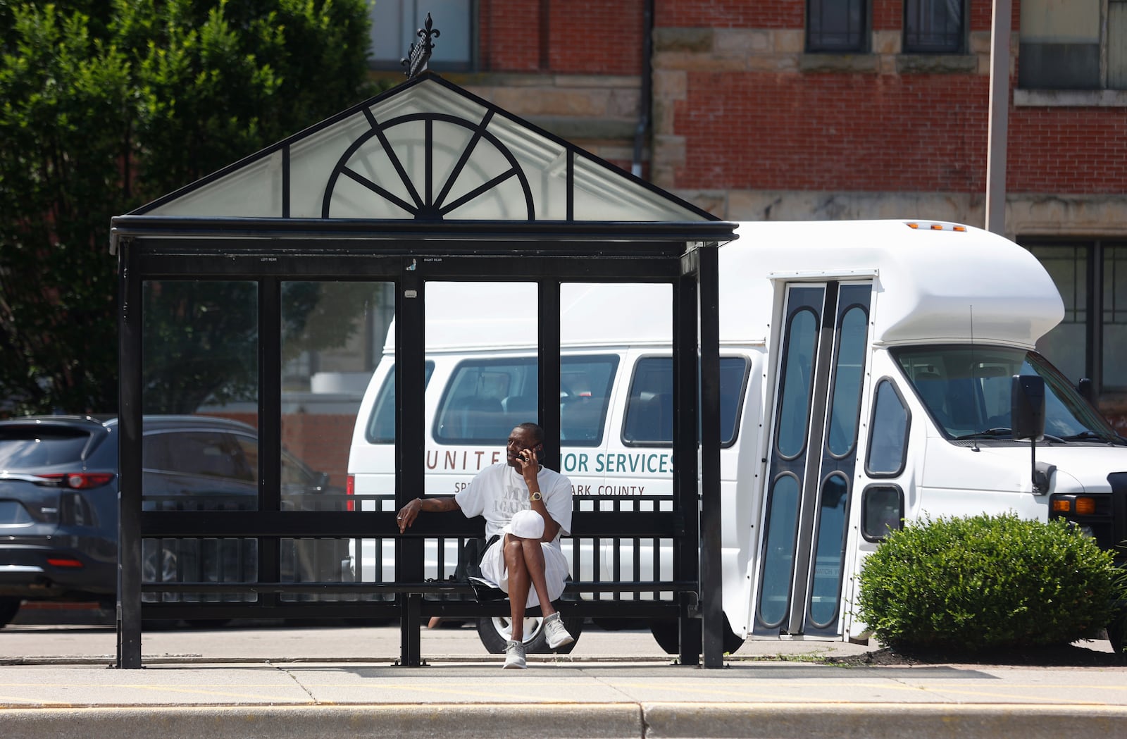 Springfield resident Michael Williams waits for a SCAT bus on the afternoon of Friday, June 20, 2025, outside the Heritage Center. JOSEPH COOKE/STAFF
