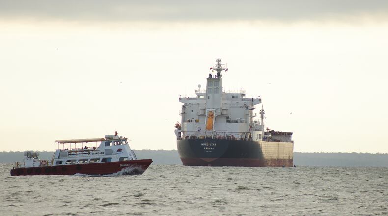A boat sails past the oil tanker Nord Star, Panama, on Lake Maracaibo, Venezuela, Wednesday, Jan. 7, 2026. (AP Photo/Edgar Frias)