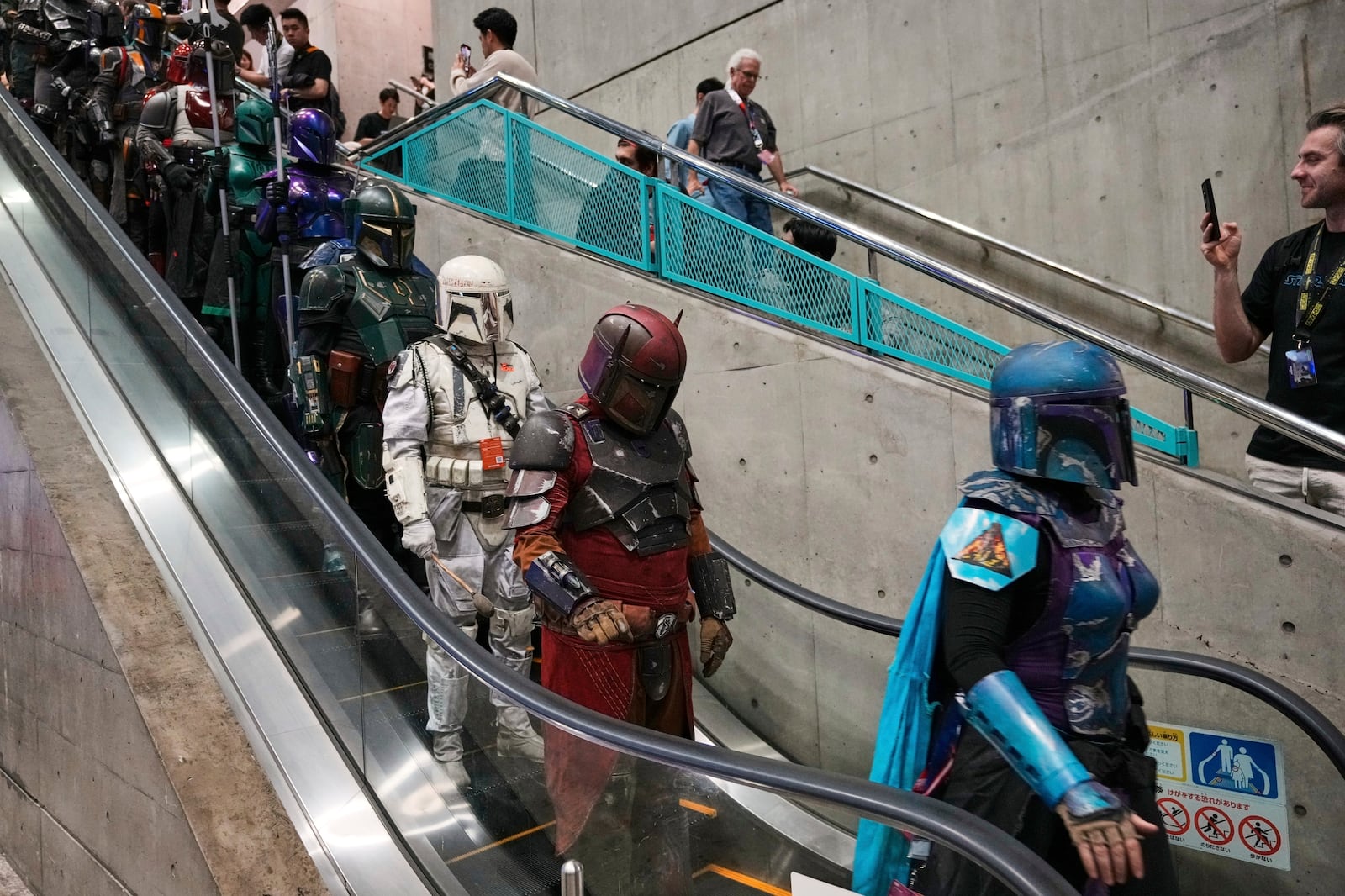 FILE - Star Wars fans in different creations of the Boba Fett uniforms attend a fan convention, the Star Wars Celebration in Chiba, near Tokyo, Friday, April 18, 2025. (AP Photo/Hiro Komae, File)