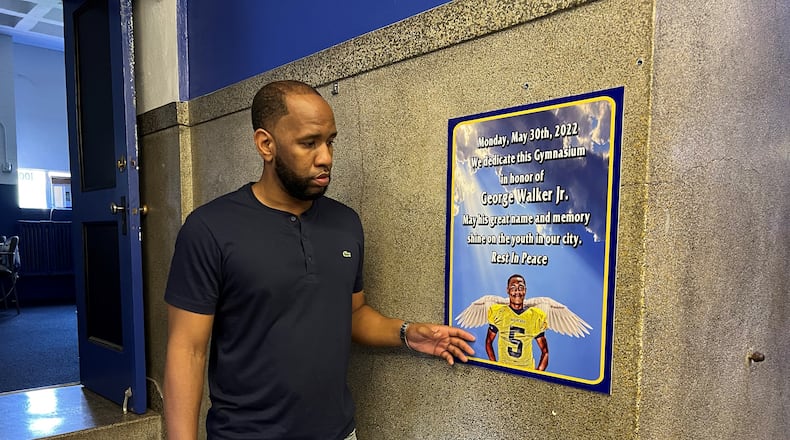 James Cooper stands next to a tribute to his late brother George Walker Jr., whose memory inspires Cooper's mission to provide a safe space for area youth. Hasan Karim/Staff