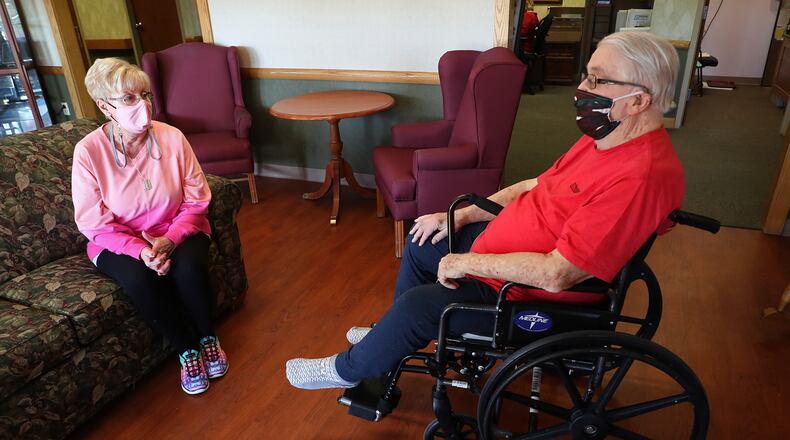 Peggy Derr visits with her husband, John, a patient at Villa of Springfield Wednesday. Villa started allowing visitation by appointments this week. BILL LACKEY/STAFF