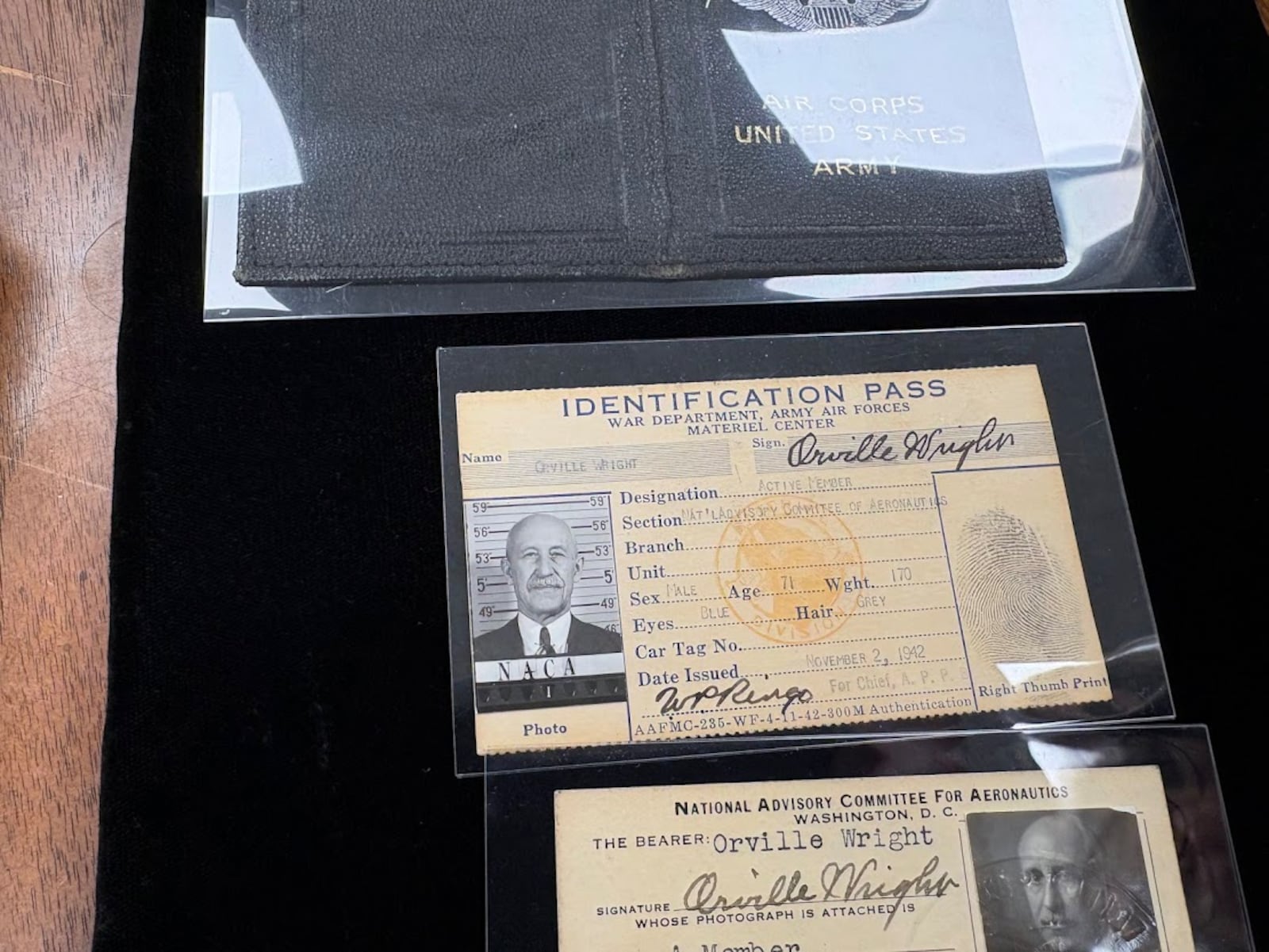 Military and government IDs for Orville Wright, found in Wright State University's collection of Wright family artifacts. THOMAS GNAU/STAFF