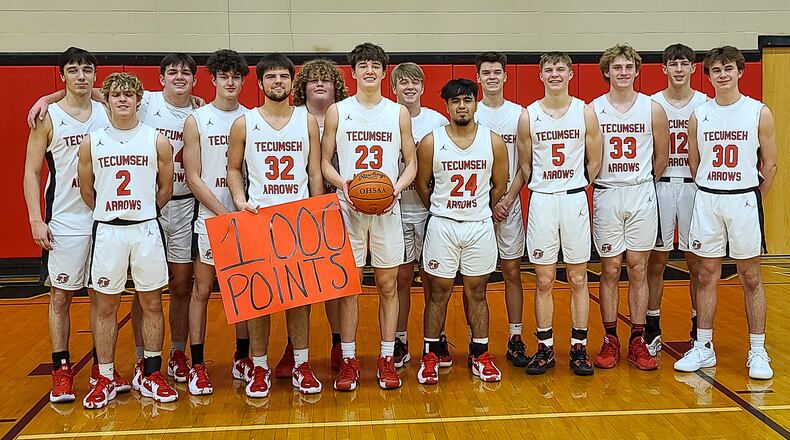 Cutline: Tecumseh High School junior Collin O'Connor (23) poses with teammates after scoring his 1,000th career point on Tuesday night in New Carlisle. O'Connor scored 34 points in the Arrows' 80-50 victory over Benjamin Logan. CONTRIBUTED PHOTO