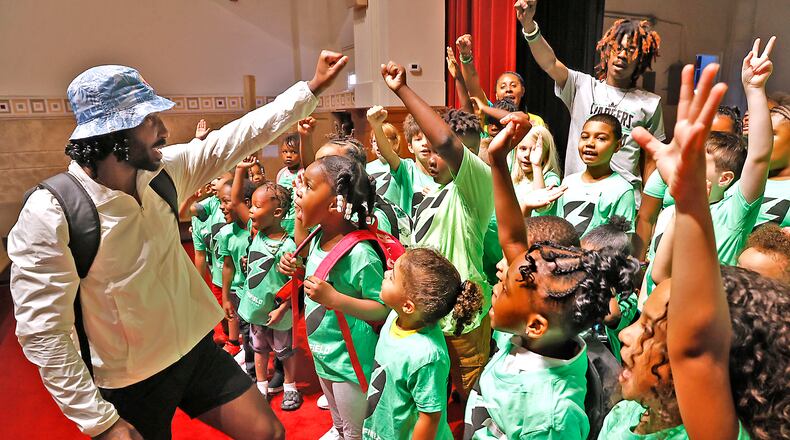 Former Ohio State football standout Braxton Miller gets the students at the Springfield Sports Academy excited for the first day of school Wednesday, August 23, 2023. Miller, a Springfield native, is teaming up with the school as it begins its first year in Springfield. BILL LACKEY/STAFF