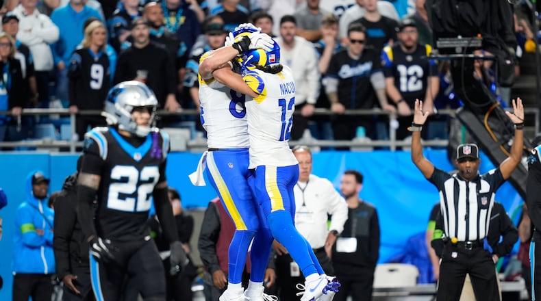Los Angeles Rams tight end Colby Parkinson, center left, celebrates his touchdown catch with wide receiver Puka Nacua (12) during the second half of an NFL wild-card playoff football game against the Carolina Panthers, Saturday, Jan. 10, 2026, in Charlotte, N.C. (AP Photo/Erik Verduzco)