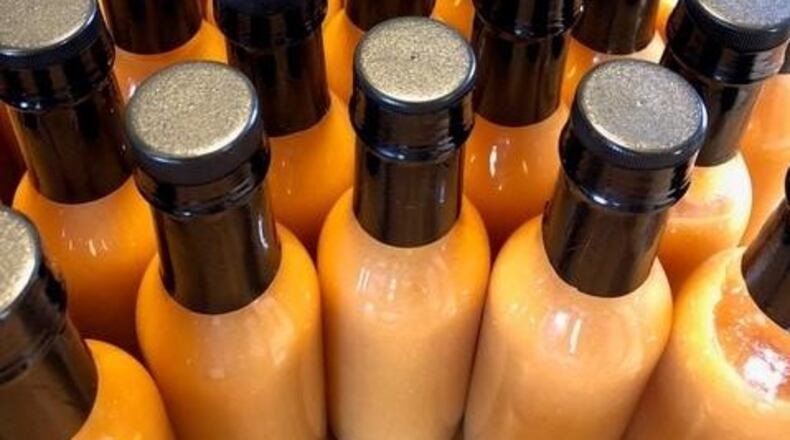 Tracy and Jeffrey McElfresh of Kettering have released JuicyMelt Supreme Hot Sauce. Varieties include Ruby Wizard (grapefruit habanero), OG Catalyst (orange ginger habanero), and All the Fun (white pepper peach). CONTRIBUTED