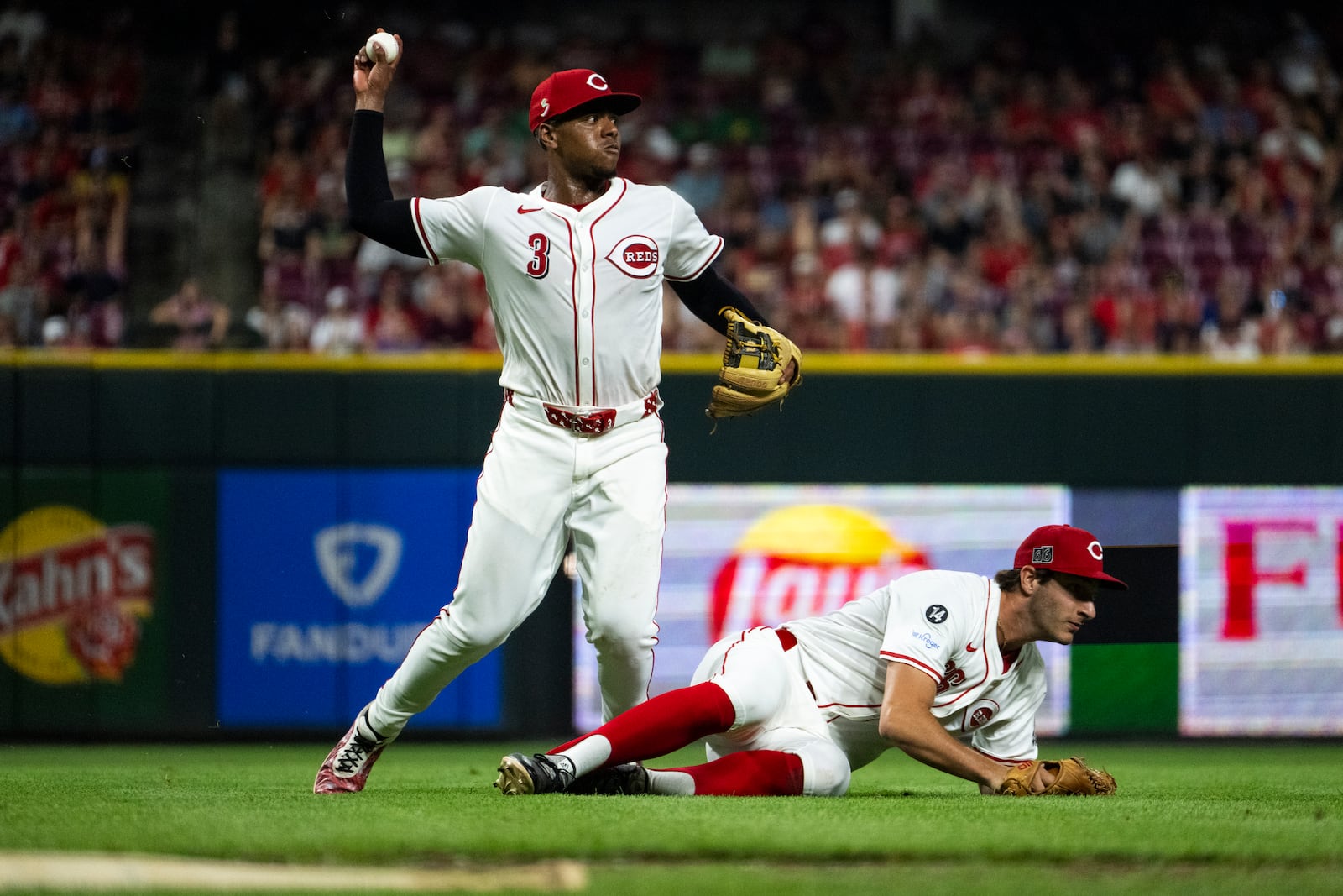 Cincinnati Reds third baseman Ke'Bryan Hayes (3) throws to first base in the 10th inning  of a baseball game against the Milwaukee Brewers, Saturday, Aug. 16, 2025, in Cincinnati. (AP Photo/Michael Swensen)