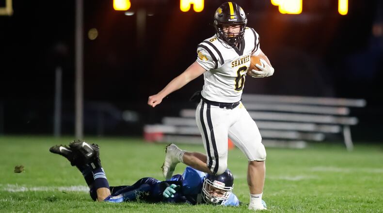 Cutline: Shawnee High School quarterback Drew Mitch rans past Blanchester's Trenton Czaika during their game on Saturday night at Blanchester High School Stadium. The Braves won 23-6. CONTRIBUTED PHOTO BY MICHAEL COOPER