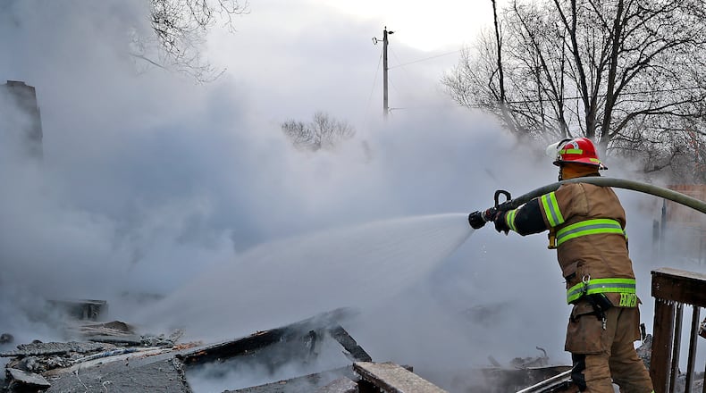 Firefighters battled the cold as well as a house fire on Scioto Street in Springfield Township Friday, Dec. 23, 2022. The City of Springfield Fire Division responded to provide mutual aid for the fire that destroyed the home. One person was transported to the hospital from the scene. The sub-zero weather caused equipment from the township and city to freeze up at the scene. BILL LACKEY/STAFF