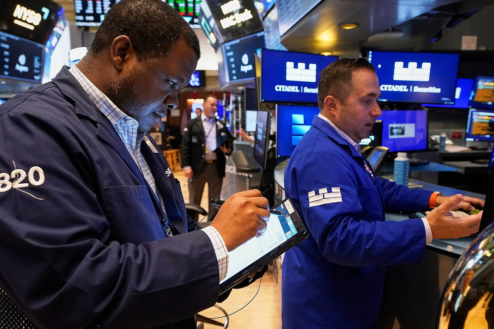Trader Thomas Lee, left, and specialist Genarro Saporito work on the floor of the New York Stock Exchange, Thursday, May 8, 2025. (AP Photo/Richard Drew)