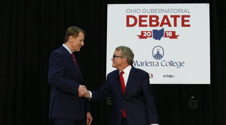 Richard Cordray, left, a Democrat and former head of the Consumer Financial Protection Bureau, and Mike DeWine, Ohio’s Republican attorney general, shake hands at a gubernatorial candidates’ debate in Marietta, Ohio, Oct. 1, 2018. Their race has been a throwback to an era where state politics were more localized and less about Washington.