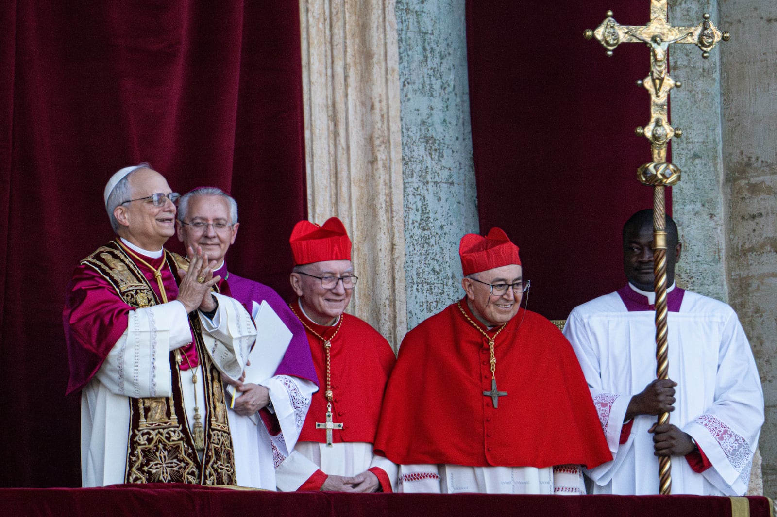 Newly elected Pope Leo XIV, left, formerly Cardinal Robert Francis Prevost, appears on the central loggia of St. Peter's Basilica at the Vatican shortly after his election as the 267th pontiff of the Roman Catholic Church, Thursday, May 8, 2025. (AP Photo/Domenico Stinellis)