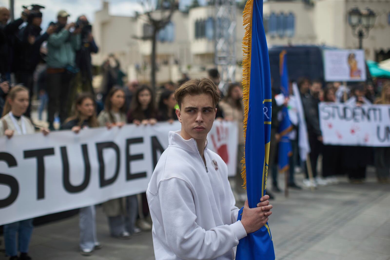 A student observes seventeen minutes of silence during an anti-corruption protest in the southwestern town of Novi Pazar, Serbia, Saturday, April 12, 2025. (AP Photo/Marko Drobnjakovic)