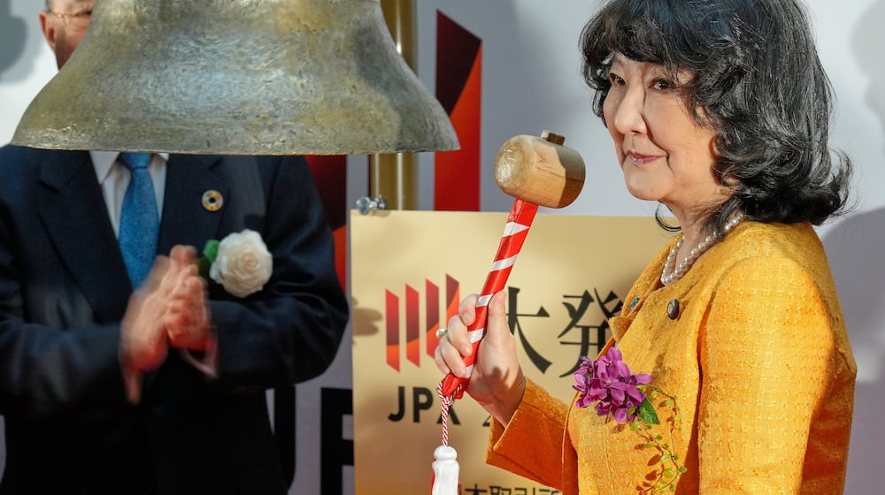 Finance Minister Satsuki Katayama rings the bell during a ceremony marking the start of trading at the Tokyo Stock Exchange, Monday, Jan. 5, 2026, in Tokyo. (AP Photo/Eugene Hoshiko)