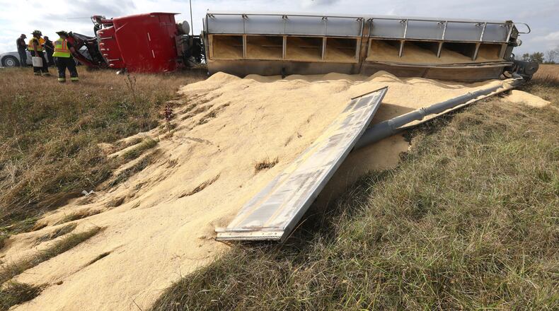 A semi truck rolled onto its side while on the I-675 north ramp to I-70 west after its load shifted. STAFF PHOTO / BILL LACKEY